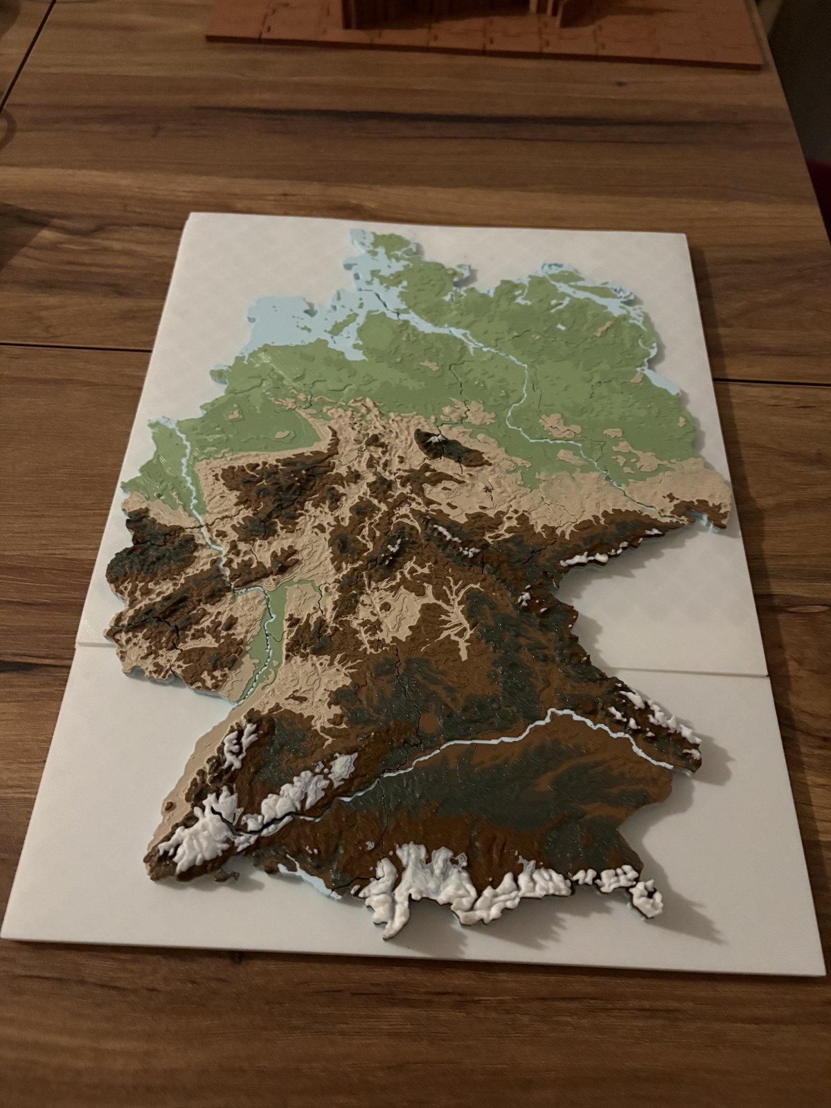 Layered geographic 3D print prototype on a white base